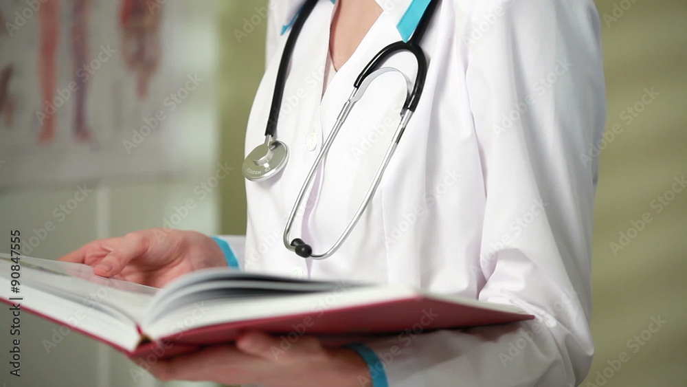 Young female doctor working with medical records in the interior. Close up. Young female doctor working with medical records in the interior. Close up.