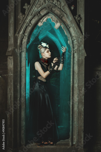 Gothic girl standing in the castle.