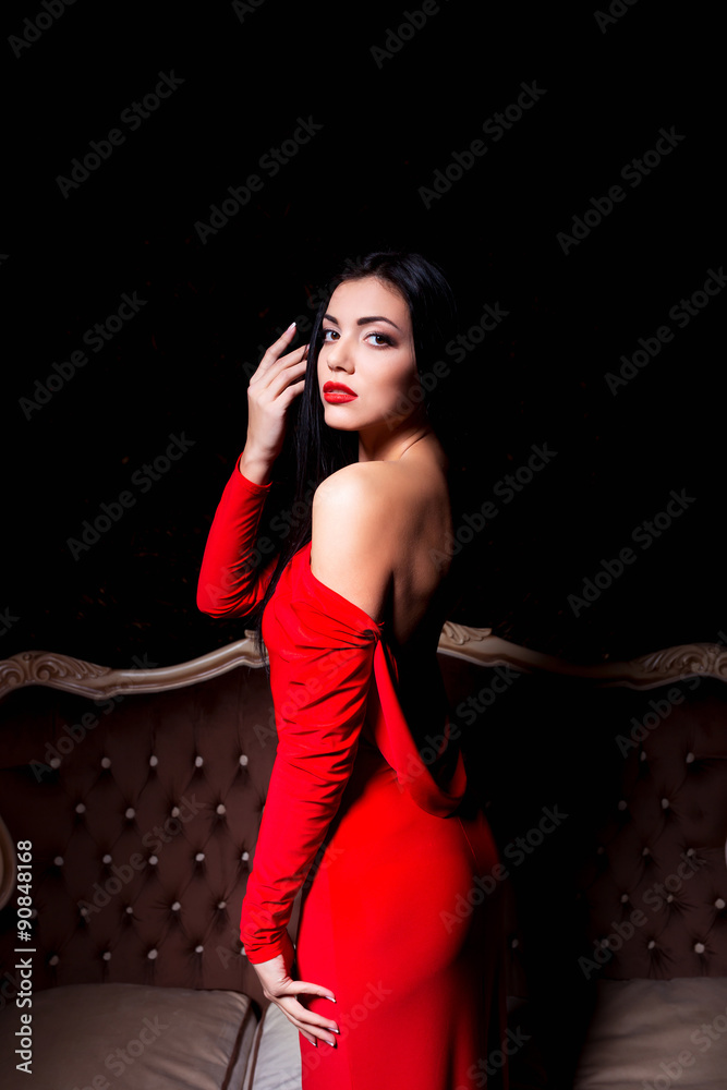 Elegant woman with make up wearing red dress posing in a sensual Elegant woman with make up wearing red dress posing in a sensual