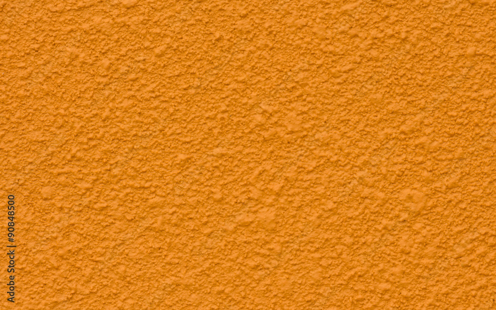Orange cement wall painted with a rough surface. Orange cement wall painted with a rough surface.
