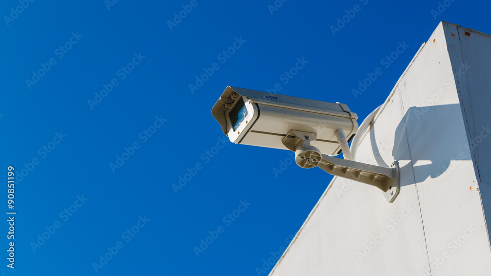 CCTV on building with blue-sky background CCTV on building with blue-sky background