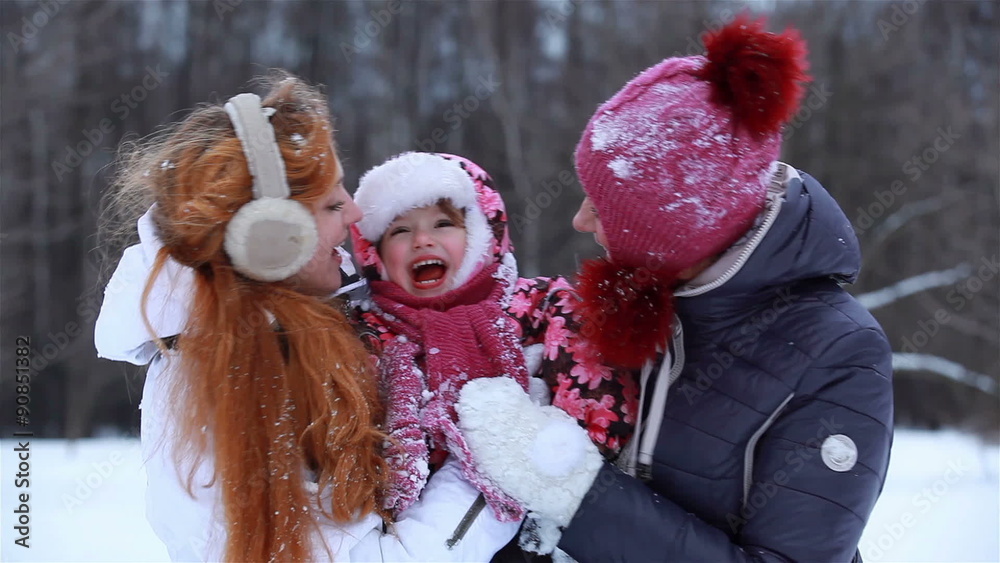 Happy together. Grandmother, mother and baby playing with snow in winter park.