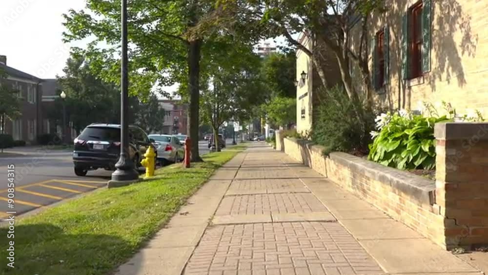 A pedestrian's point of view of walking down a sidewalk in Wooster, Ohio.