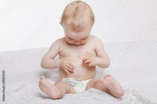 Baby untersucht sich selbst die Haut und schaut fragend