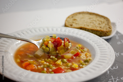 bowl of vegetable soup with bread 