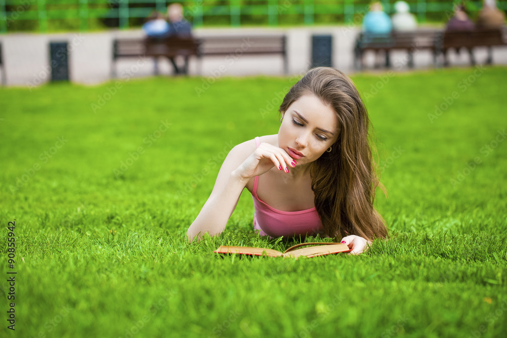 Young beautiful brunette girl reading a book outdoor Young beautiful brunette girl reading a book outdoor