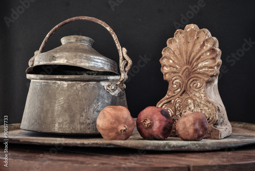 old copper pot. cooker, bowl and pomegranate fruit