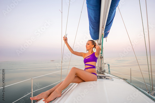 Girl makes selfie on the yacht. 