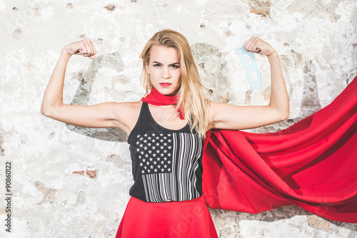 Strong woman posing in front of the camera and shoving biceps photo