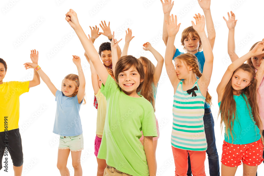 Happy kids boys and girls with lifted hands Happy kids boys and girls with lifted hands