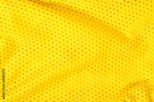 Yellow textile pattern as a background. Close up on yellow crumpled material with holes texture on fabric.