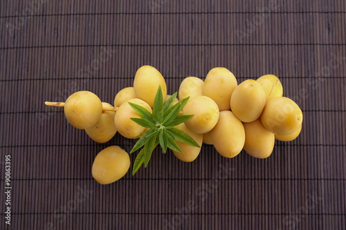 Very fresh organic dates from Israel, freshly picked, grown on farm, decorated with lemon verbena leaves. photo