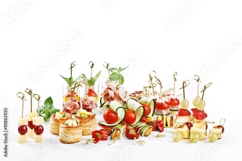 Fotografia great attractive set of canapes with vegetables, cheese, fruits, berries, salami