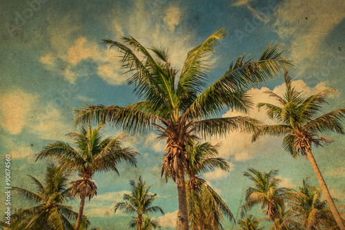 Coconut palm tree with blue sky day. Grunge old paper filter.