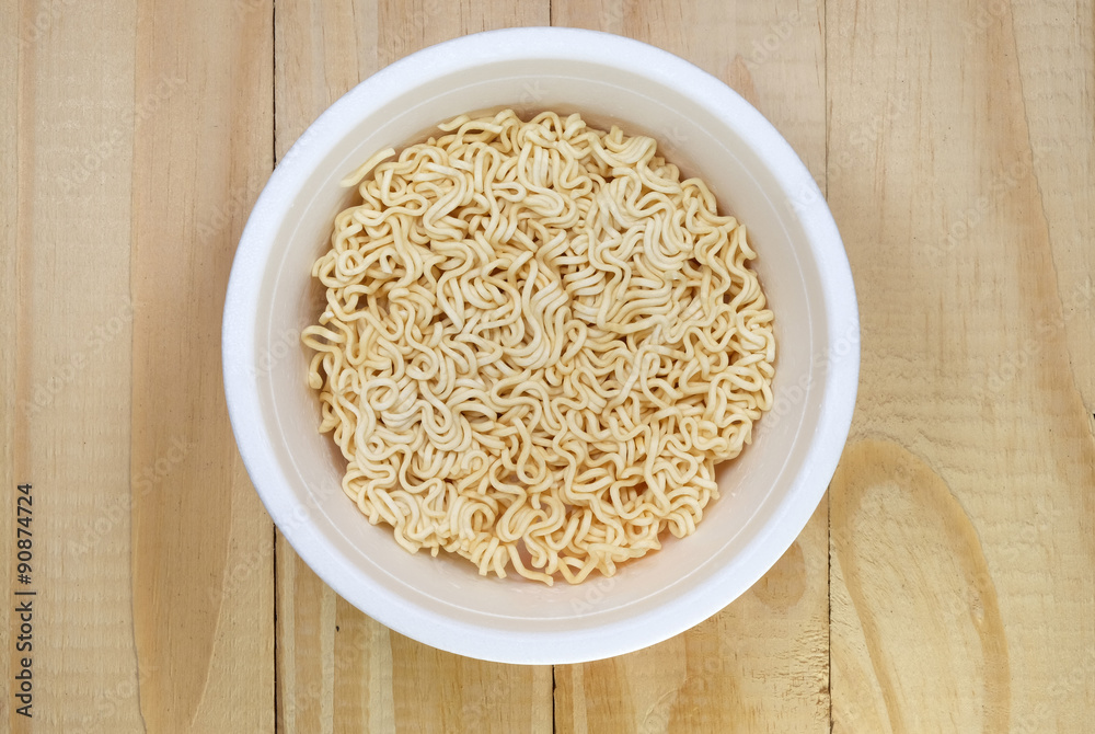 Instant noddles in white bowl on woods Instant noddles in white bowl on woods