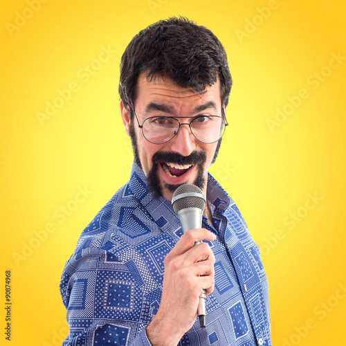 Vintage young man singing with microphone