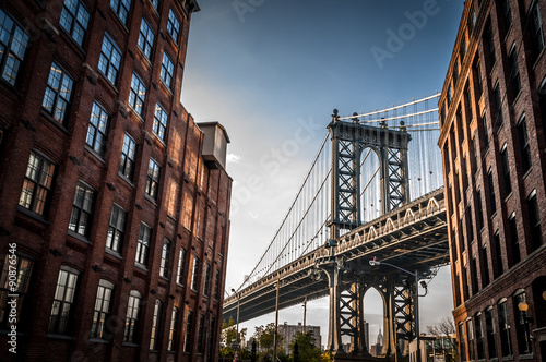 Wallpaper Mural Manhattan bridge seen from a narrow alley enclosed by two brick buildings on a s
