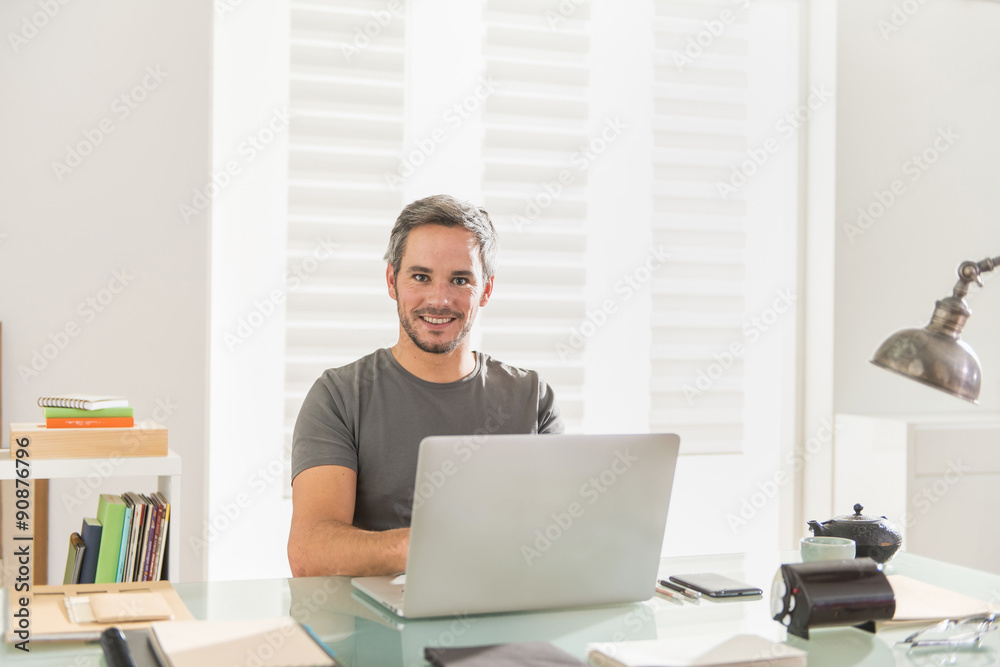 architect sitting at office working on his laptop