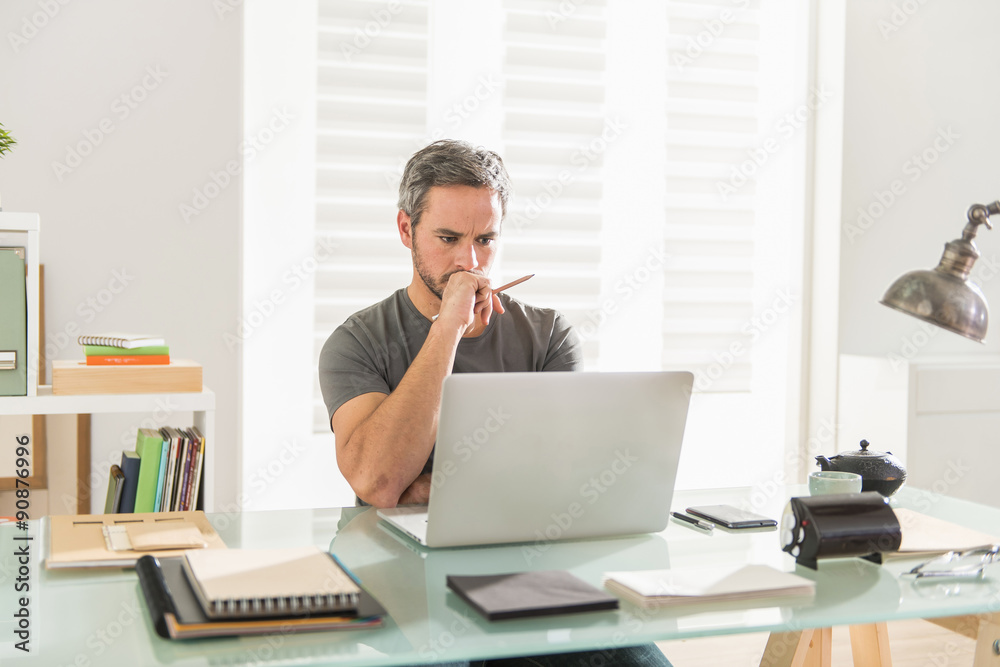 designer sitting at office working on his laptop designer sitting at office working on his laptop