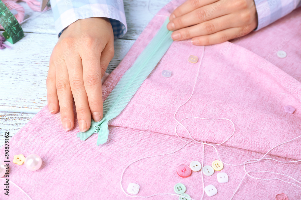 Closeup hands of seamstress at work with cloth fabric Closeup hands of seamstress at work with cloth fabric