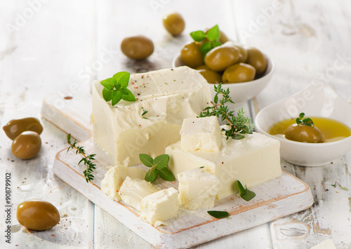 Feta cheese with green olives and herbs.