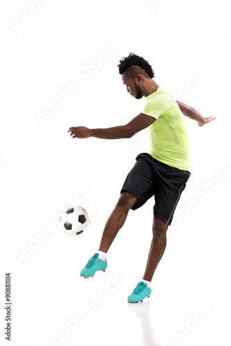 Kicking soccer ball © DragonImages