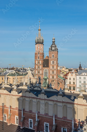 Krakow, Poland, Virgin Mary church on the Main Market Square seen over Sukiennice (Cloth Hall) from the Town Hall tower late afternoon #90882358