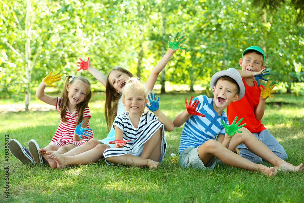Fototapeta premium Happy active children with bright colored palms in park