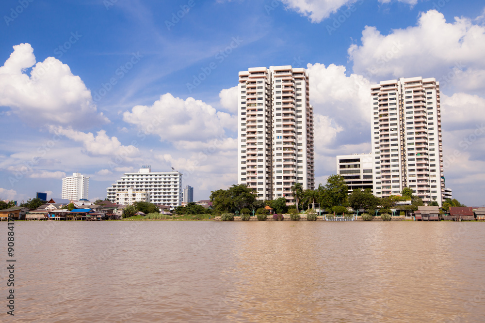 Fototapeta premium riverside modern office building on bule sky at noon day.