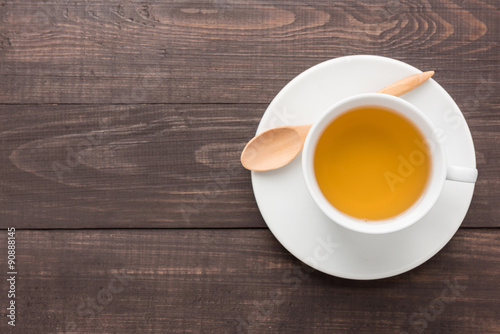 Ginger tea with lemon on the wooden background
