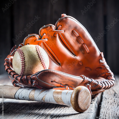 Golden glove and old baseball ball