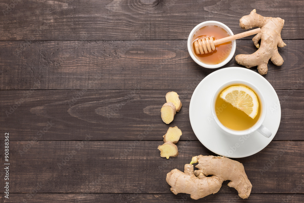 Cup of ginger tea with lemon and honey on wooden background Cup of ginger tea with lemon and honey on wooden background