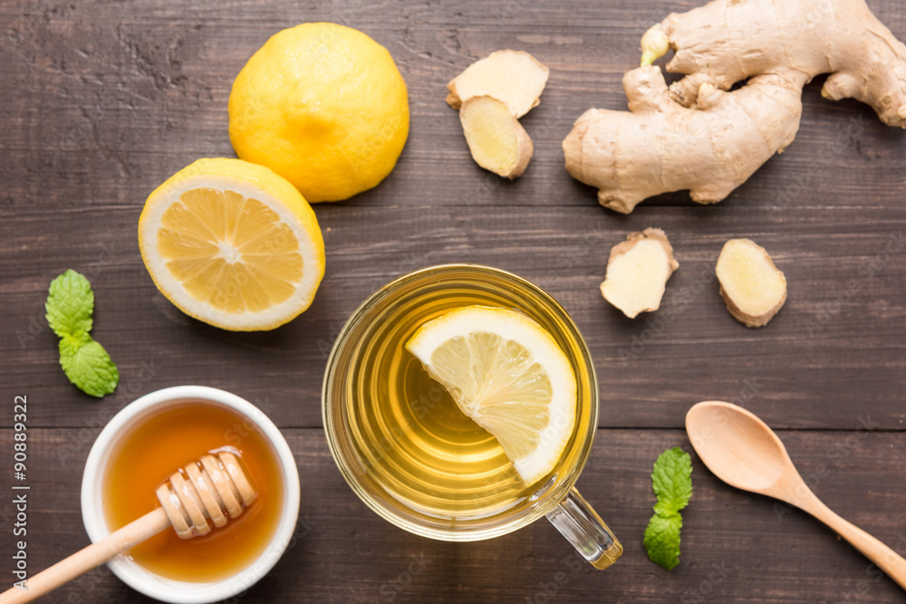 Cup of ginger tea with lemon and honey on wooden background Cup of ginger tea with lemon and honey on wooden background