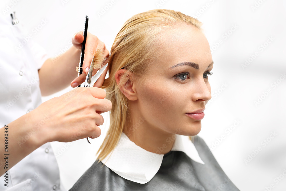 Obraz premium Kobieta u fryzjera.Strzyżenie włosów w salonie fryzjerskim