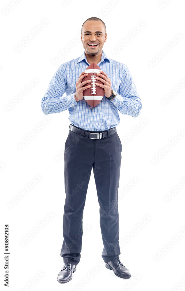 Businessman holding american football ball Businessman holding american football ball
