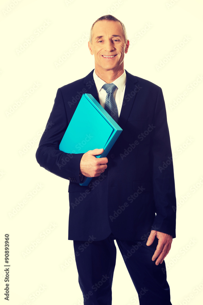 Mature businessman holding a binder Mature businessman holding a binder