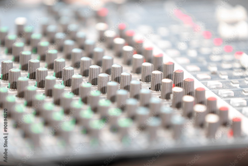 An expert adjusting audio mixing console An expert adjusting audio mixing console