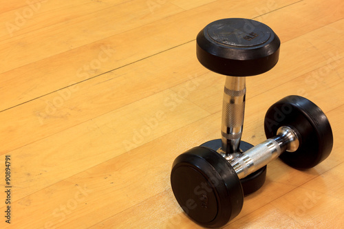 dumbbells on wood background.