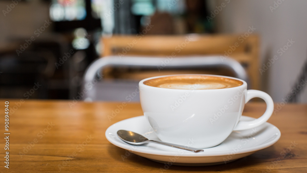 Fototapeta premium Hot art Latte Coffee in a cup on wooden table.
