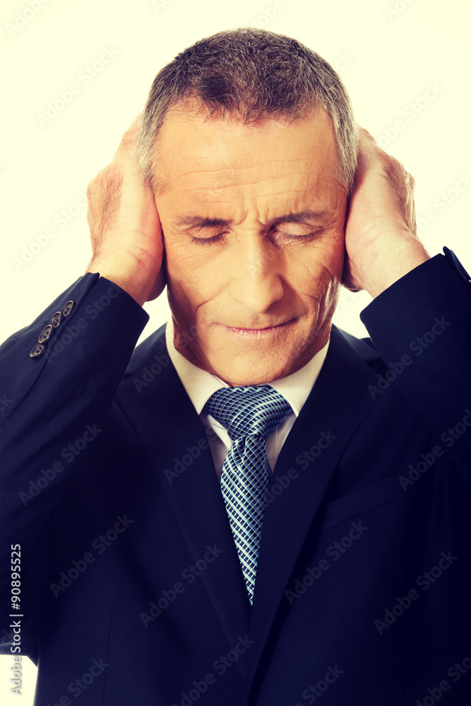 Portrait of tired man covering ears with hands Portrait of tired man covering ears with hands
