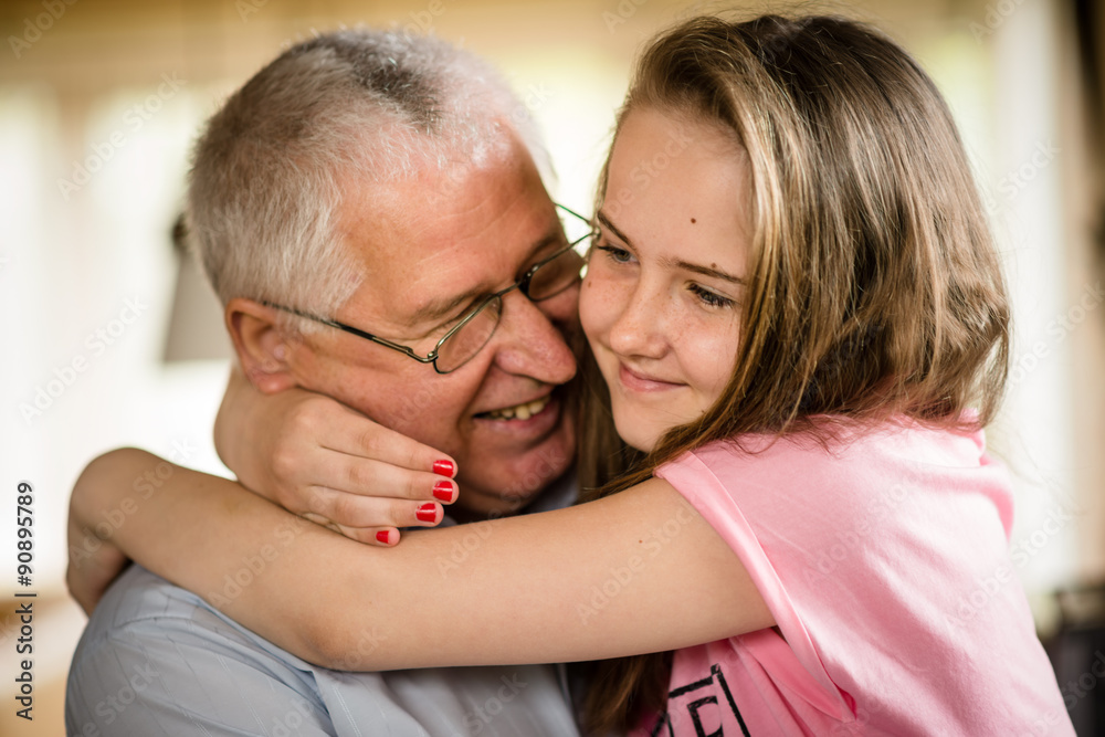 Grandfather and granddaghter hug