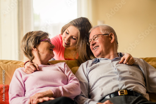 Grandchild with grandparents at home photo