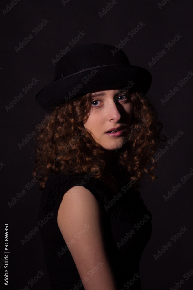Low key portrait of beautiful girl in black hat Low key portrait of beautiful girl in black hat