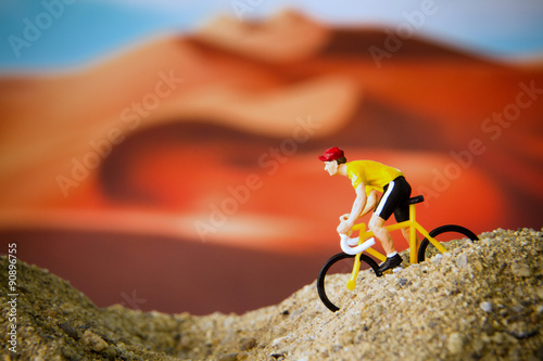 Miniature toy bicycle in desert