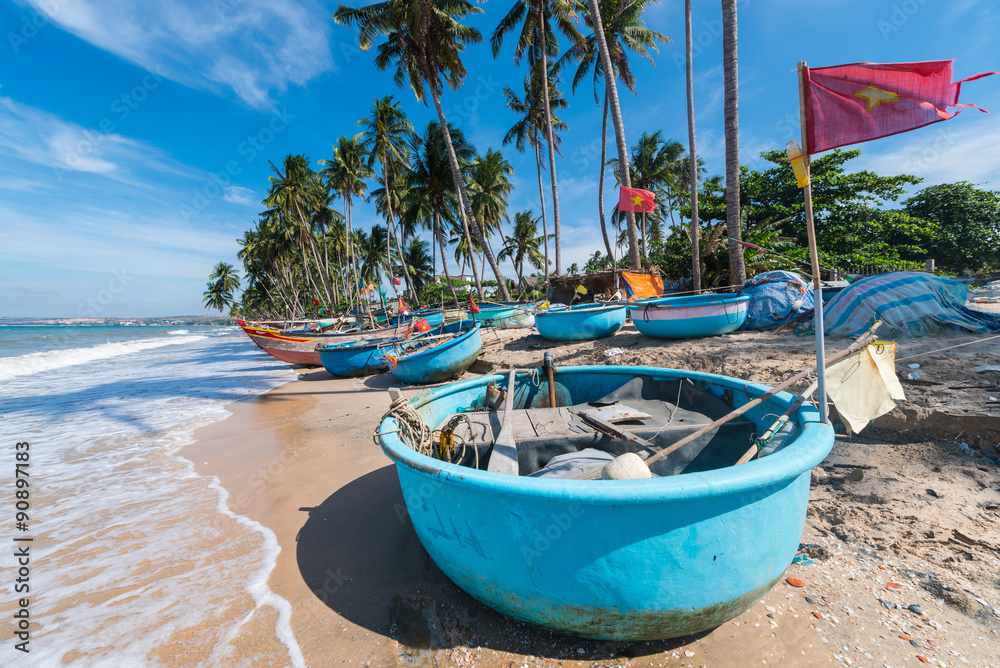Vietnamese fishing coracles on beach, tribal boats at fishing vi