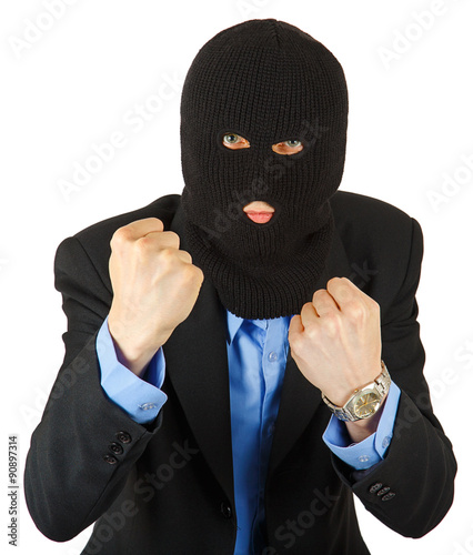 Thief in black mask in suit holding his fists