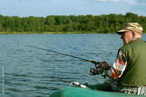 Spinning fisherman on a boat fishing