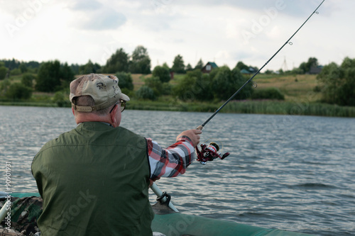 Spinning fisherman on a boat fishing