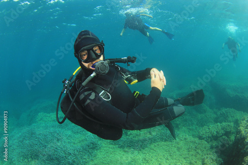 Scuba diving instructor supervises open water students