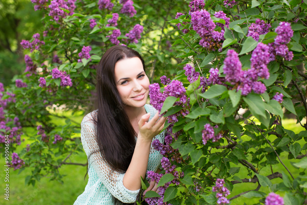 Girl smelling the lilac flowers Girl smelling the lilac flowers
